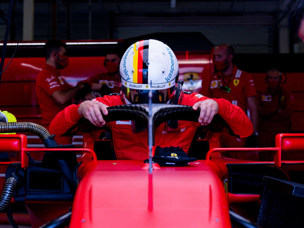 Sebastian Vettel climbs into Ferrari.jpg