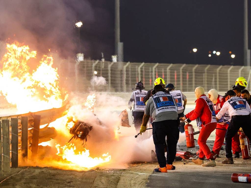 Marshals extinguish the fire in Romain Grosjean's car the Bahrain Grand Priix
