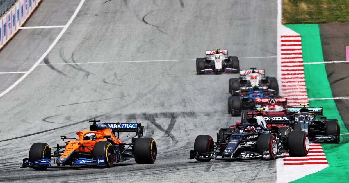 Daniel Ricciardo, McLaren, challenged by Yuki Tsunoda's AlphaTauri