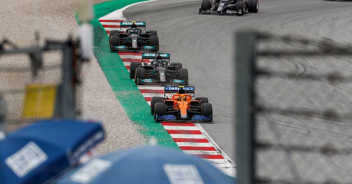 Lando Norris in his McLaren leads the two Mercedes cars of Lewis Hamilton and Valtteri Bottas