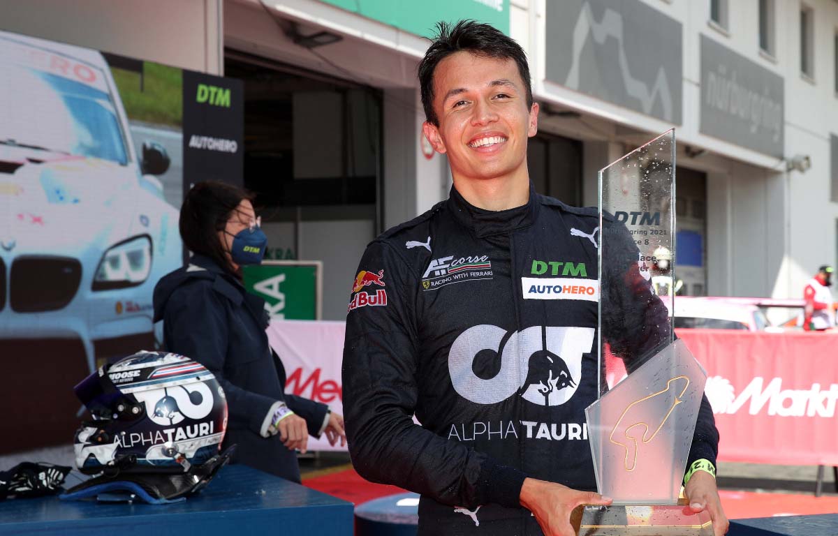 Alex Albon holds a first-place trophy at a DTM race. Nurburgring August 2021.