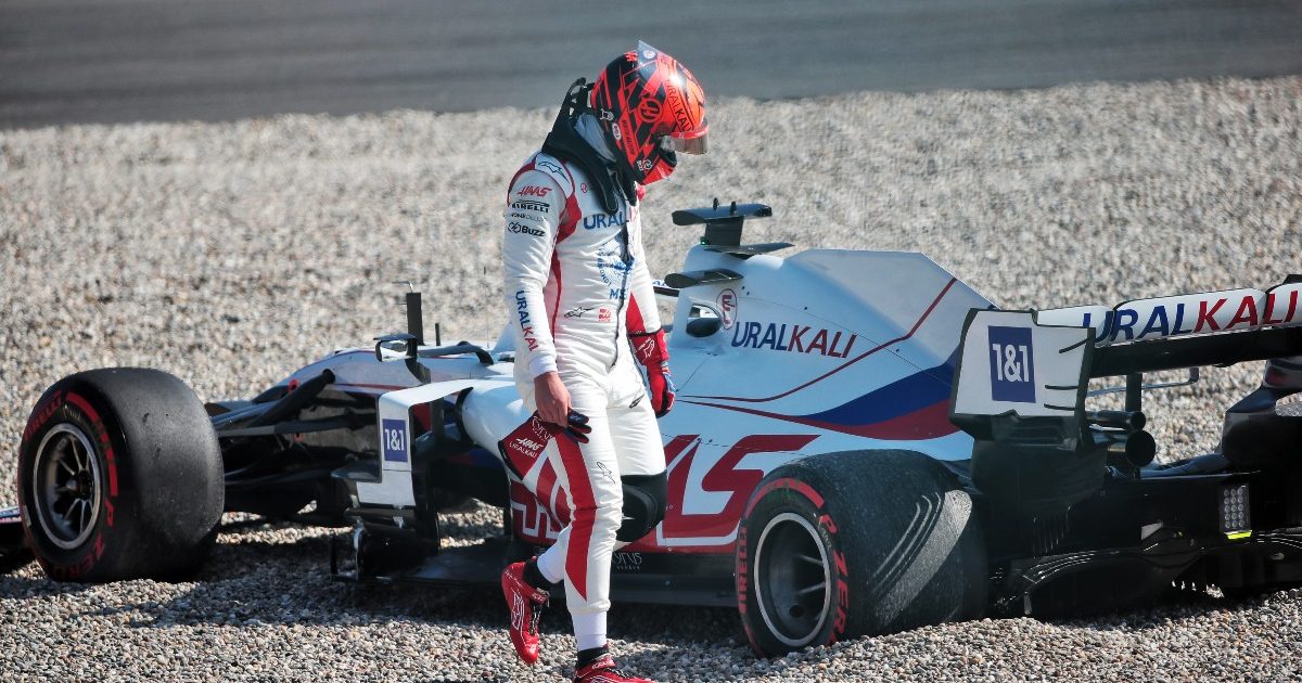 Nikita Mazepin walking away from his gravel-beached car. Netherlands September 2021