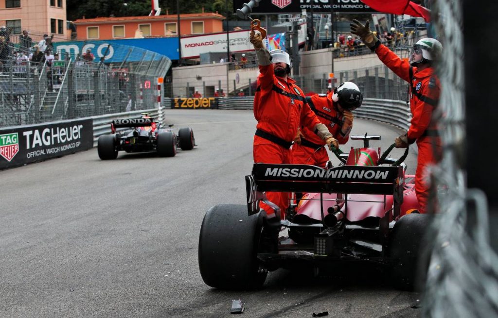 Marshals attend to Charles Leclerc's crashed Ferrari during Monaco GP qualifying. Monte Carlo May 2021.