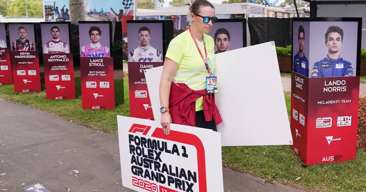 Staff remove boards promoting the Australian GP after it was cancelled. Melbourne March 2020.