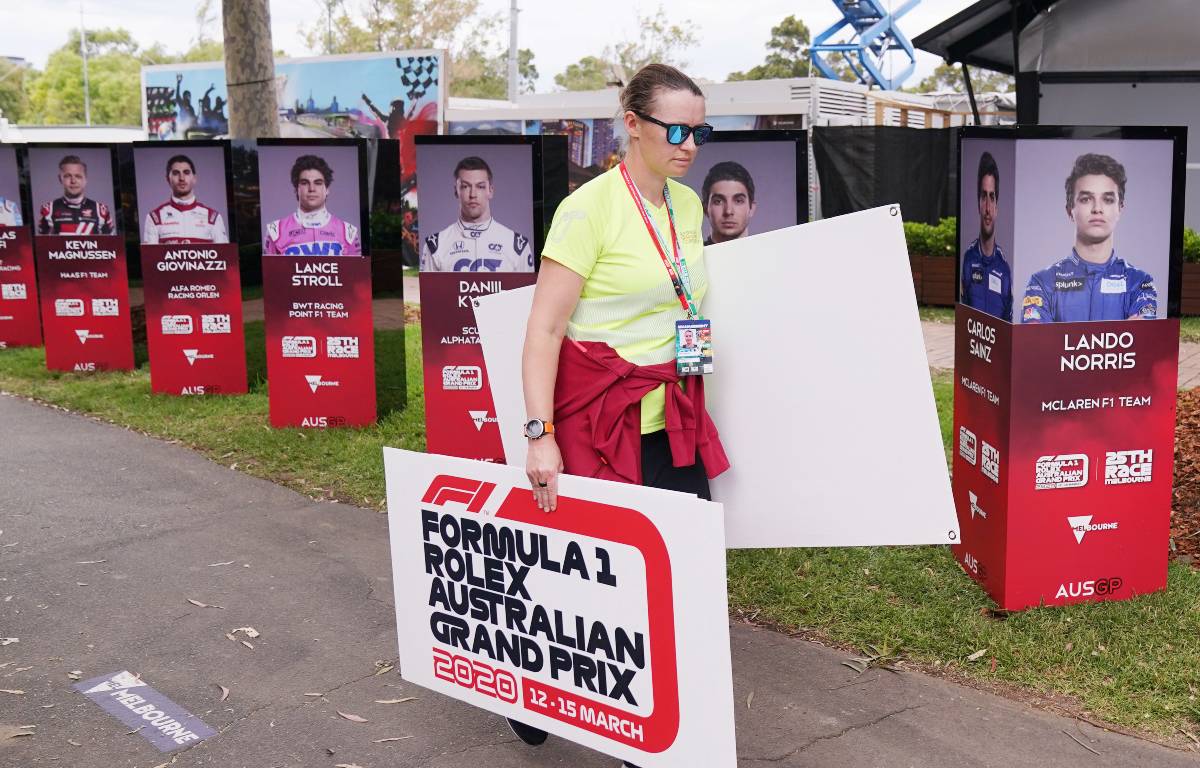 Staff remove boards promoting the Australian GP after it was cancelled. Melbourne March 2020.