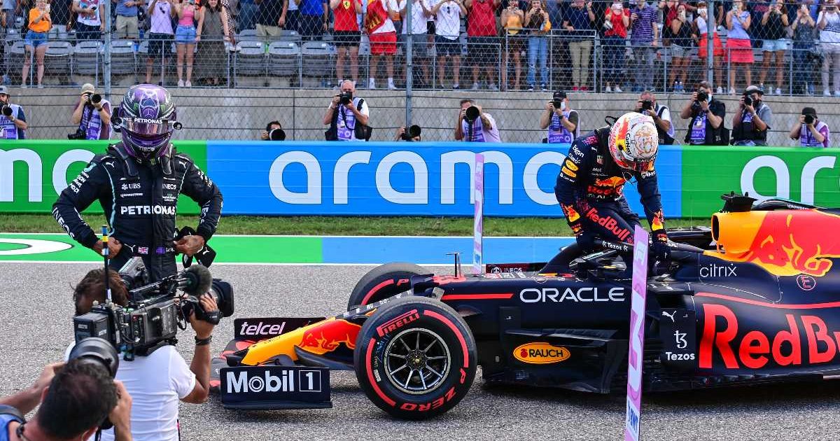 Lewis Hamilton hands on hips while Max Verstappen exits his Red Bull. United States, October 2021.