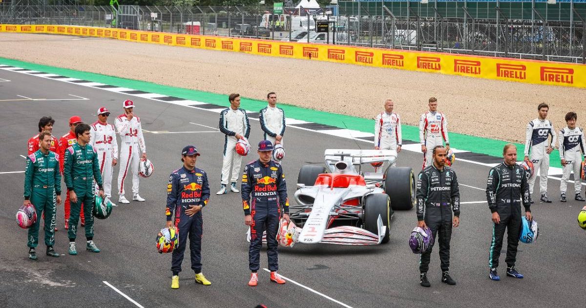 Drivers pose next to a prototype of the 2022 F1 car. Silverstone July 2021.
