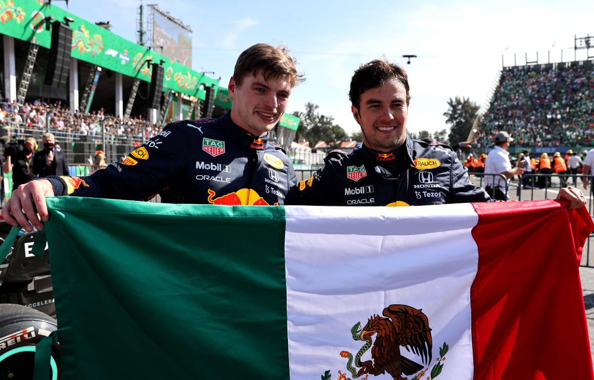 Max Verstappen and Sergio Perez holding a Mexican flag. Mexico City November 2021.