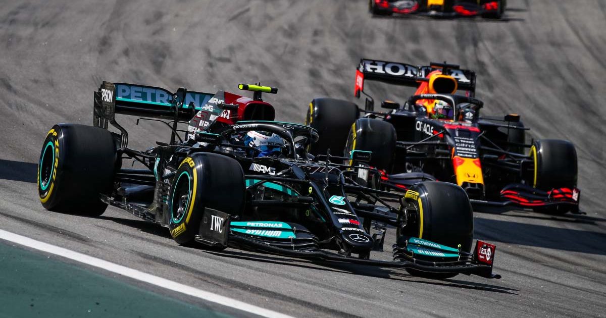 Mercedes driver Valtteri Bottas goes into Turn 1 ahead of Max Verstappen. Brazil November 2021.