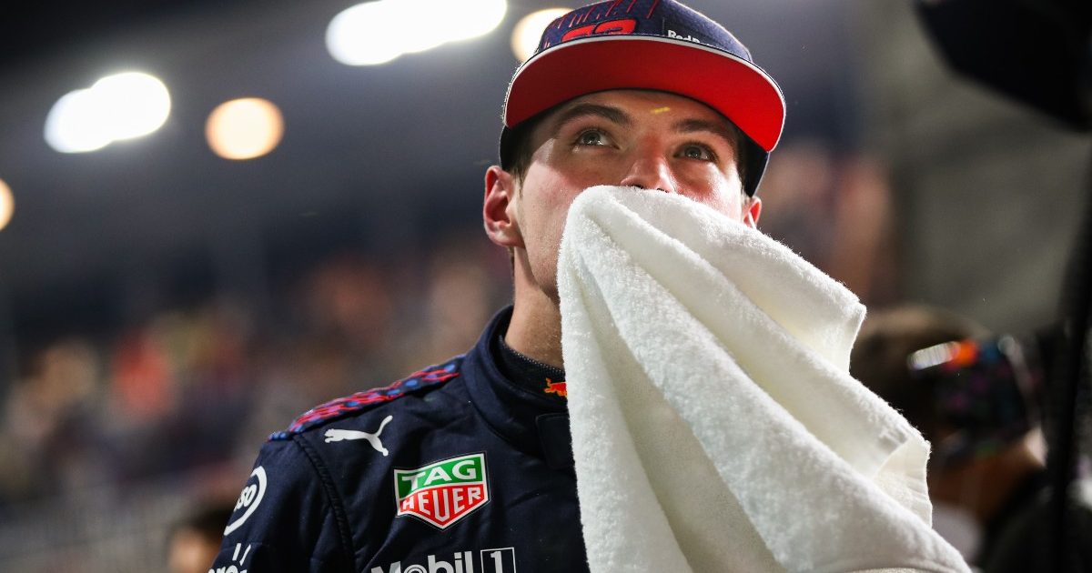 Max Verstappen wipes his face with a towel. Qatar, November 2021.