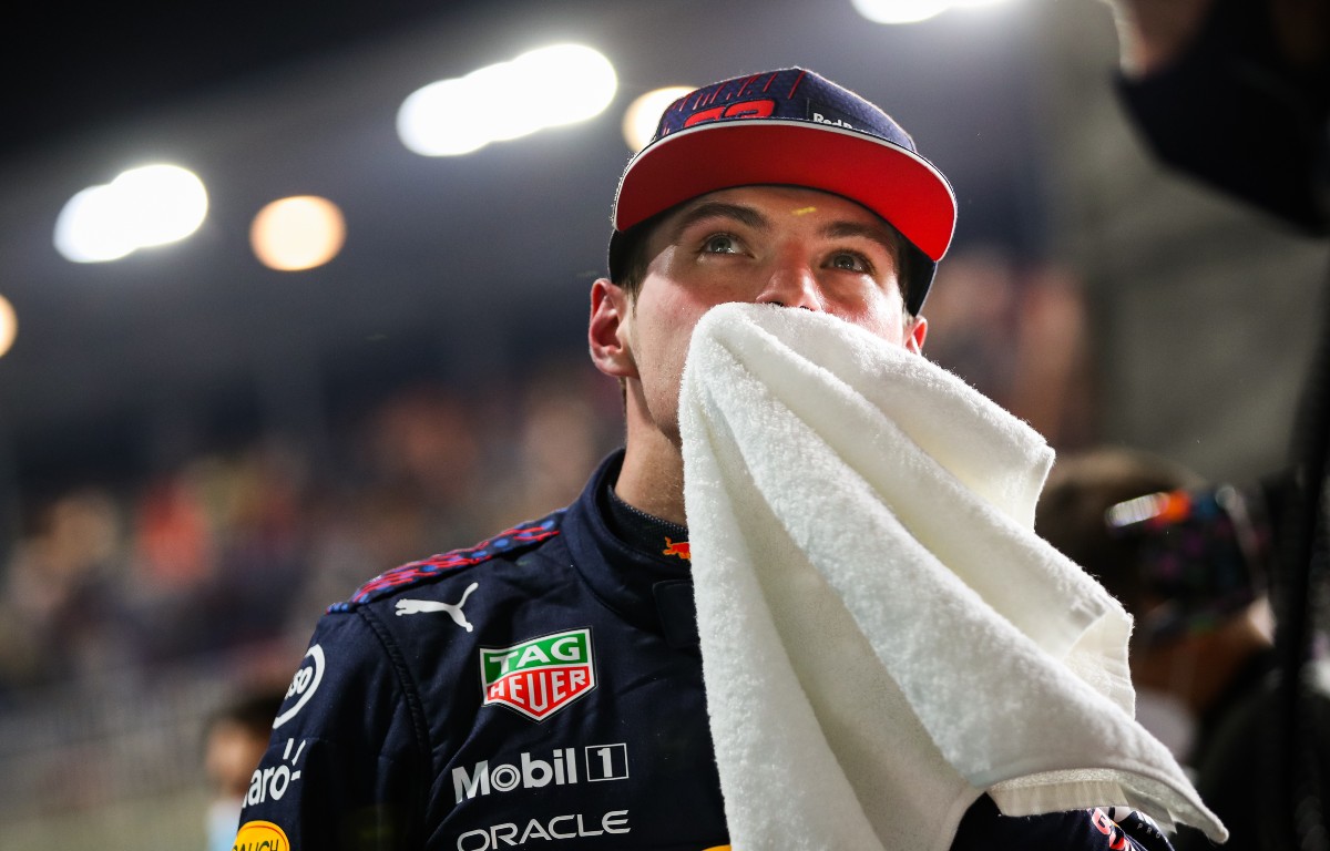 Max Verstappen wipes his face with a towel. Qatar, November 2021.