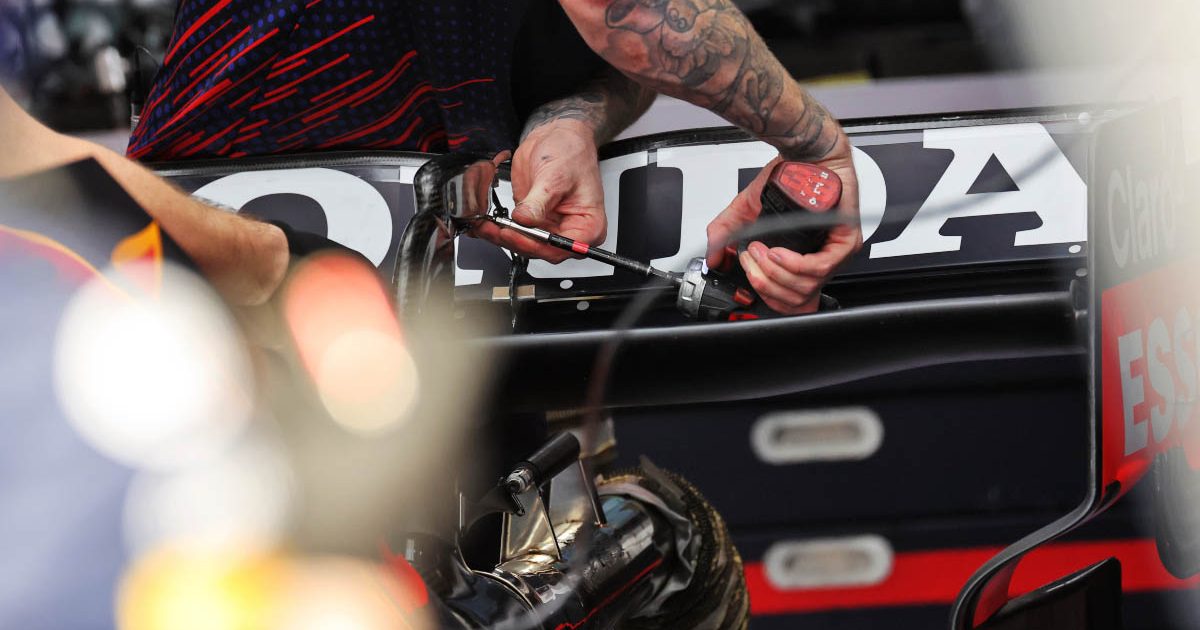 A Red Bull mechanic works on the rear wing. Qatar November 2021.