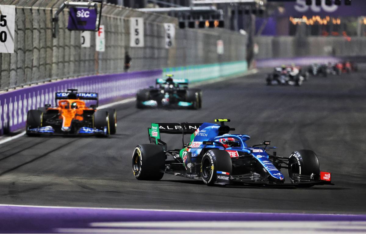 Esteban Ocon heads a train of cars during the Saudi Arabian GP. Jeddah December 2021.