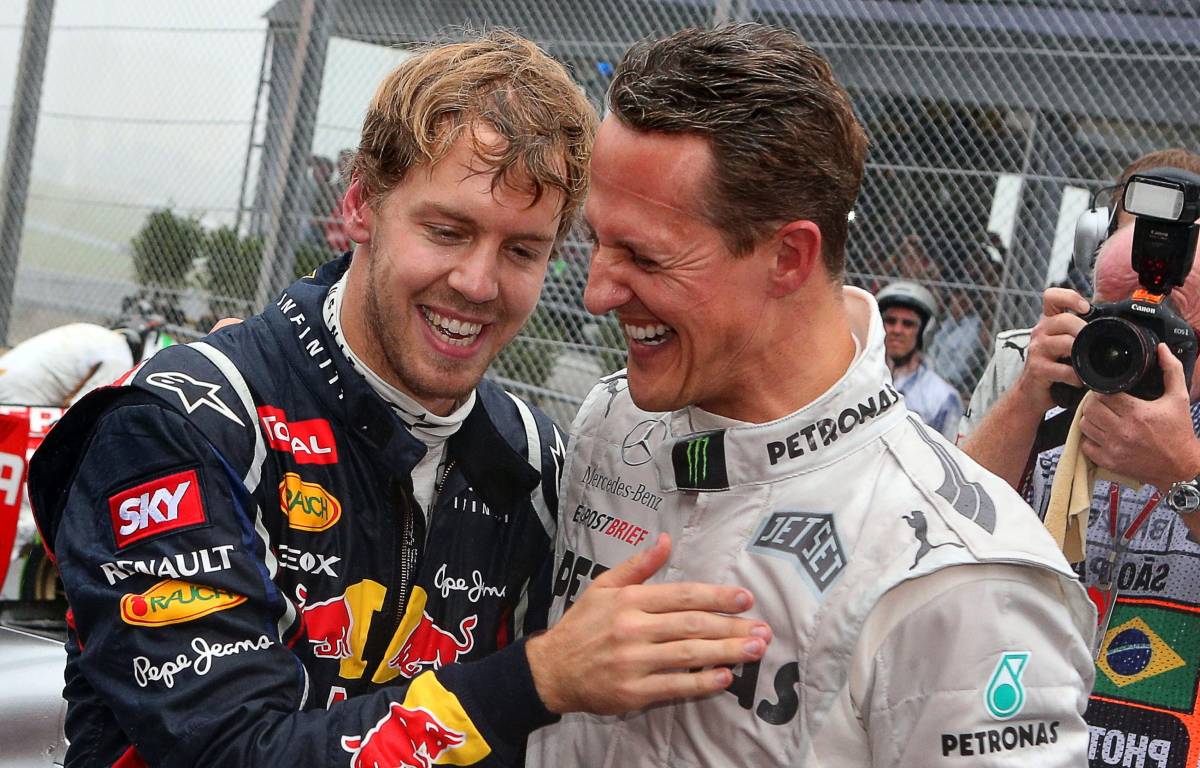 Sebastian Vettel and Michael Schumacher embrace. Brazil, November 2012.