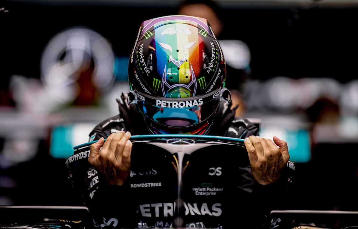 Lewis Hamilton climbing into his car. Abu Dhabi December 2021