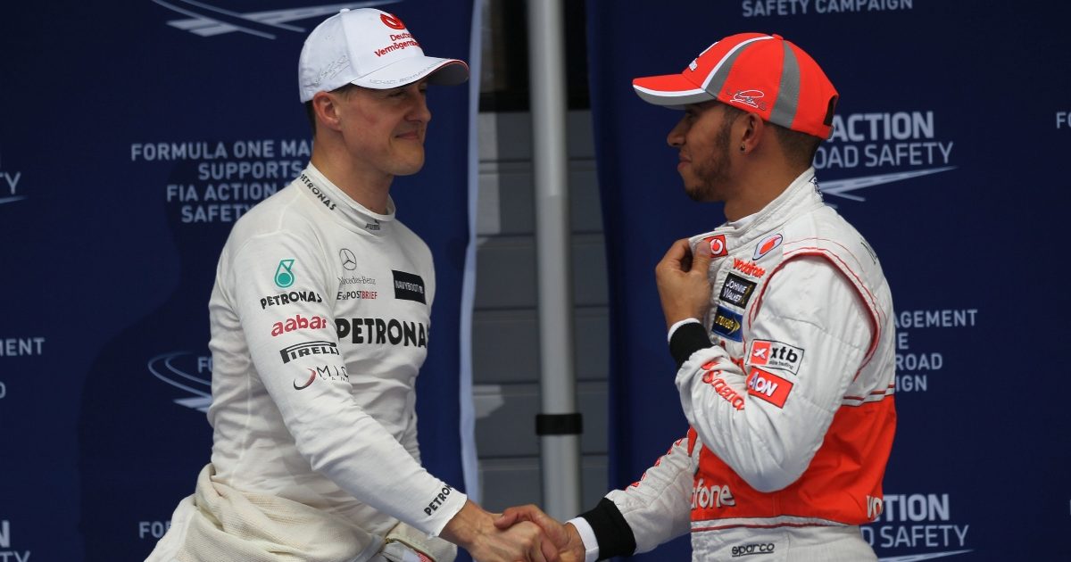 Michael Schumacher and Lewis Hamilton shaking hands. China April 2012