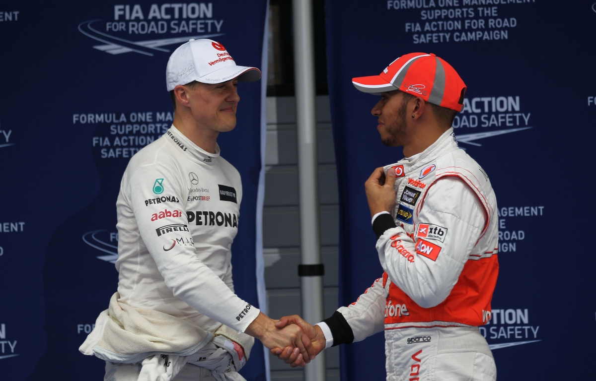 Michael Schumacher and Lewis Hamilton shaking hands. China April 2012