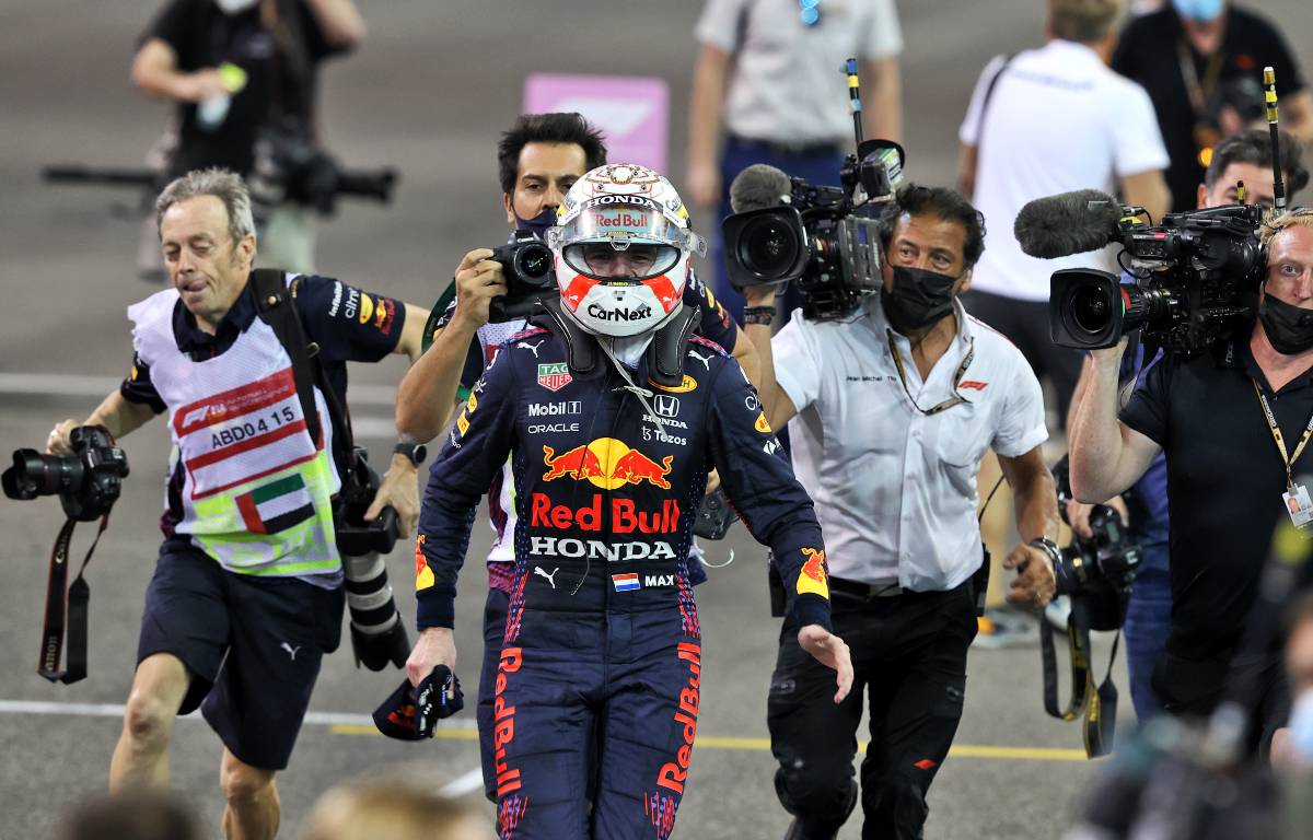 Camera men and photographers chase Max Verstappen. Abu Dhabi, December 2021.