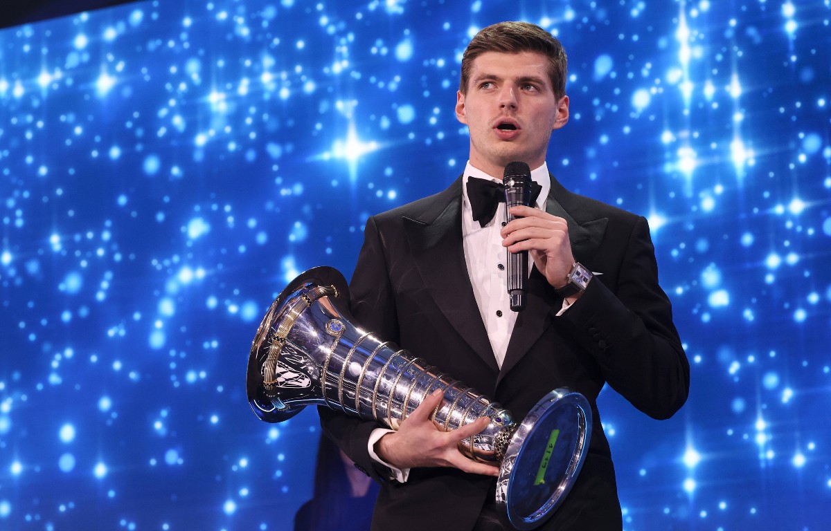 Max Verstappen speaks, holding his World Championship trophy. France, December 2021.