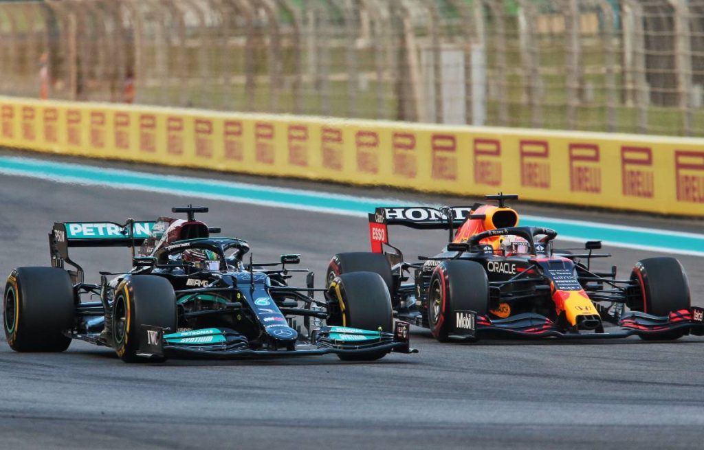 Lewis Hamilton's Mercedes alongside Max Verstappen's Red Bull. Yas Marina December 2021.