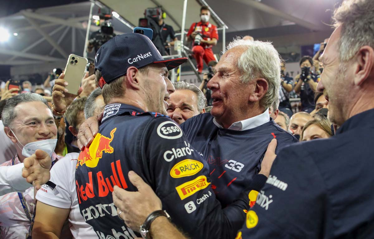 Max Verstappen and Red Bull motorsport advisor Helmut Marko embrace. Abu Dhabi December 2021.
