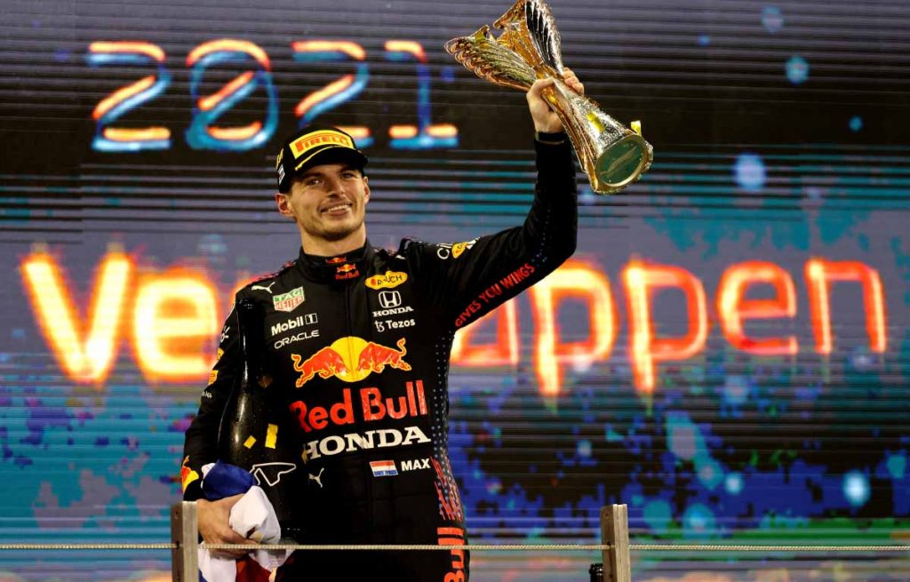 Max Verstappen holds the trophy aloft. Abu Dhabi December 2021.