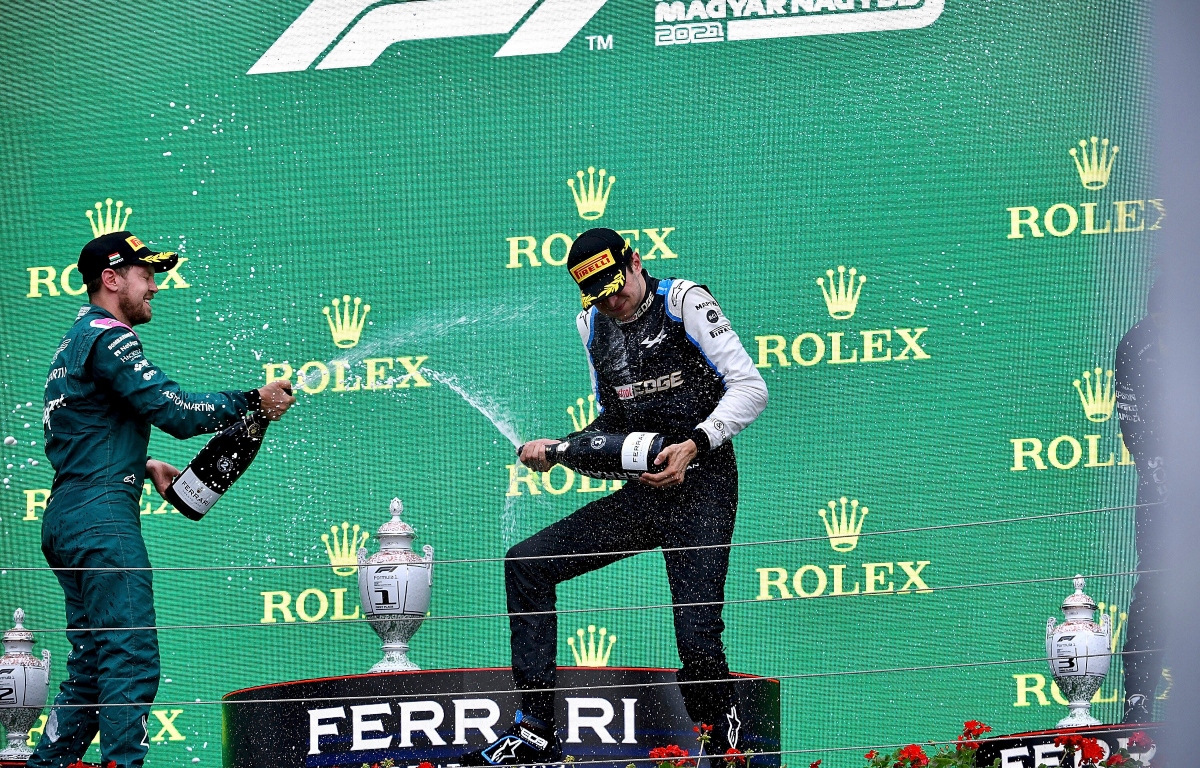 Sebastian Vettel and Esteban Ocon spraying champagne. Hungary August 2021