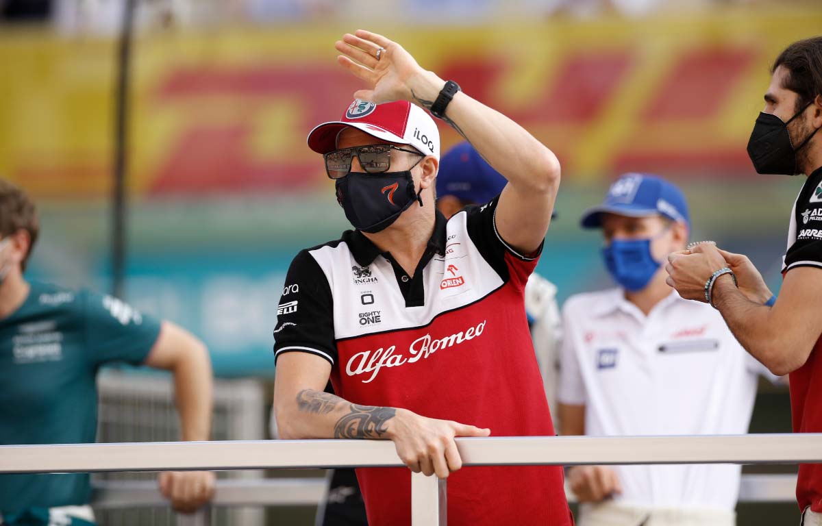 Kimi Raikkonen waves on the drivers' parade. Abu Dhabi December 2021.
