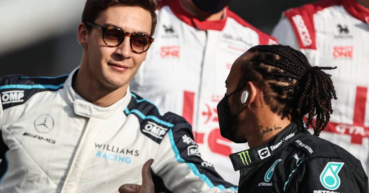 George Russell and Lewis Hamilton exchange a greeting. Yas Marina December 2021.