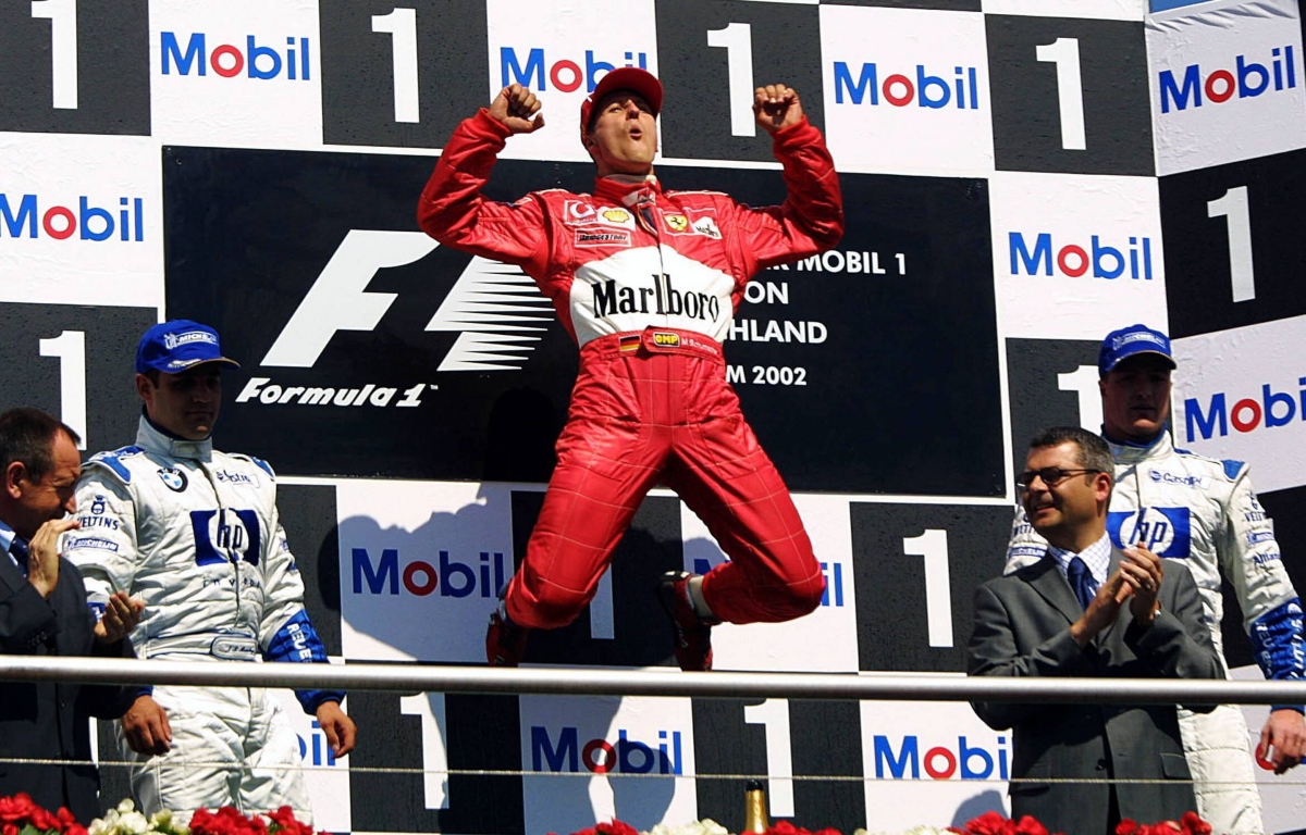 Michael Schumacher jumping for joy on the podium.