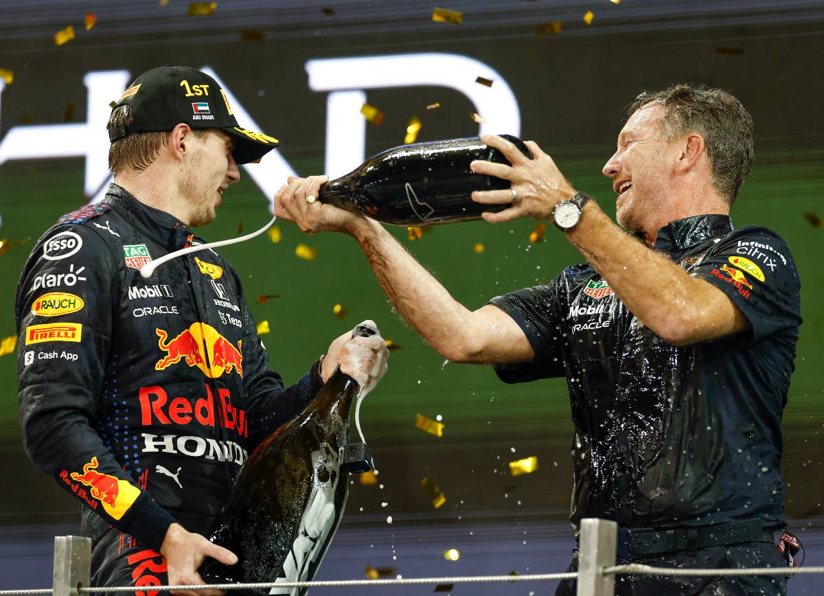 Christian Horner pours champagne on Max Verstappen. Abu Dhabi December 2021.