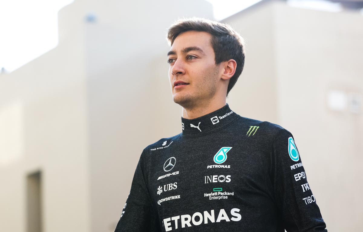 George Russell walks in Mercedes overalls. Abu Dhabi December 2021.