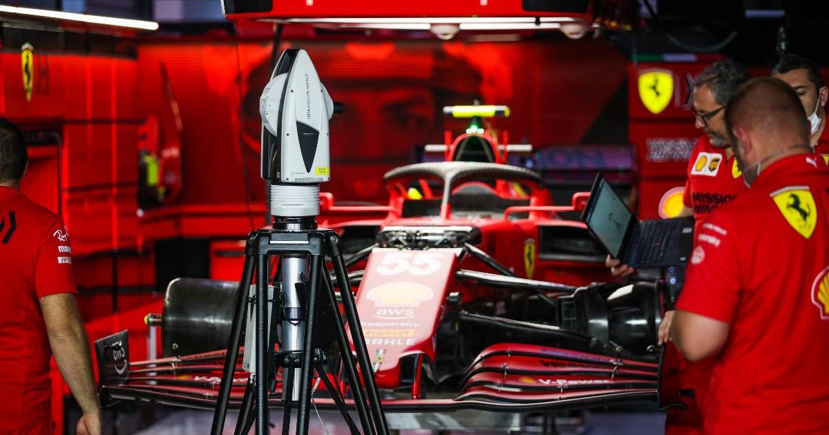 Mechanics work on Carlos Sainz's Ferrari at the Qatar GP. Lusail November 2021.