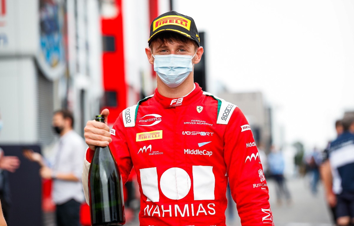 Arthur Leclerc holds a champagne bottle following his F3 victory. France, June 2021.