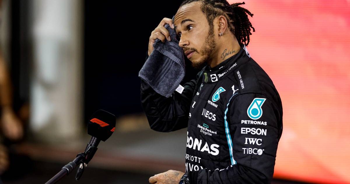 Lewis Hamilton mops his head with a towel after the Abu Dhabi GP. Yas Marina December 2021.