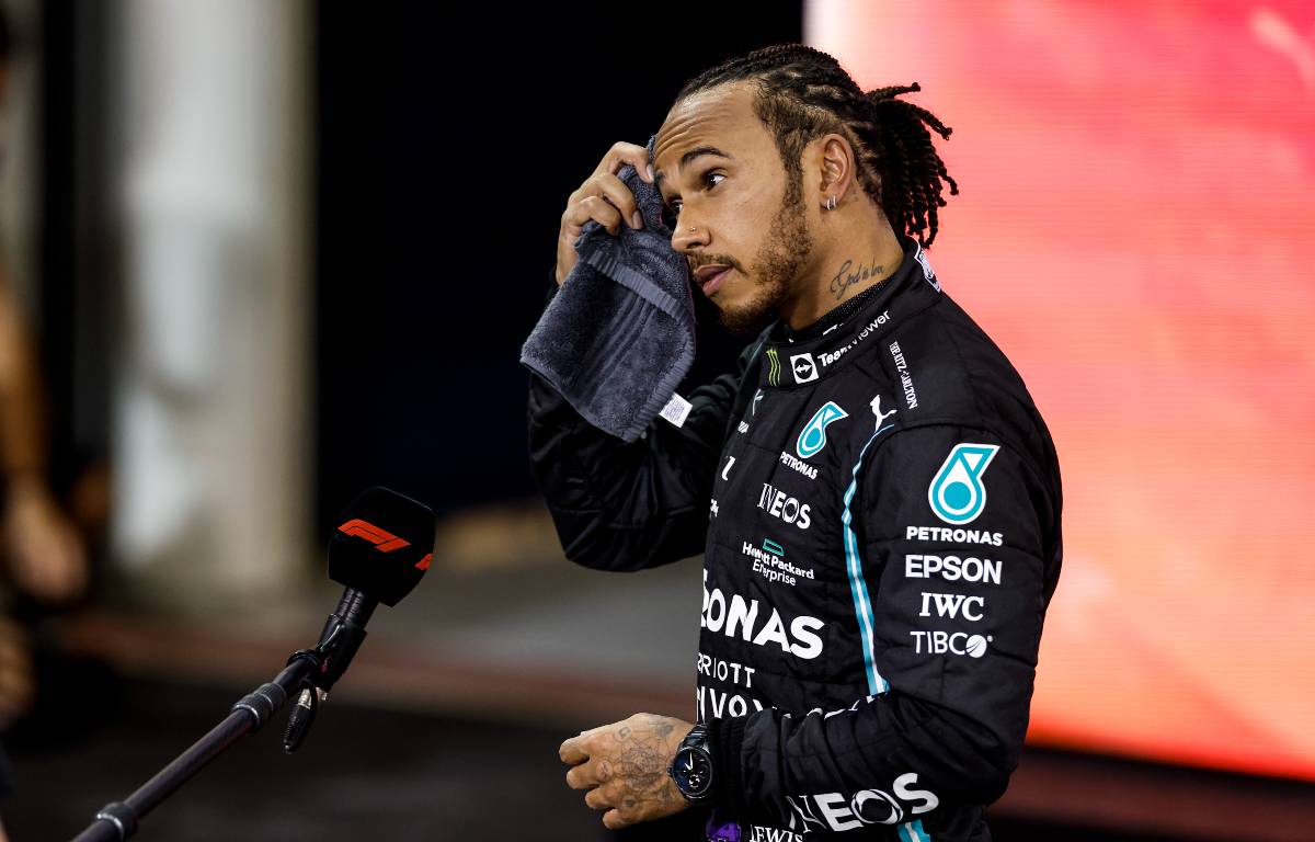 Lewis Hamilton mops his head with a towel after the Abu Dhabi GP. Yas Marina December 2021. Heartbreak