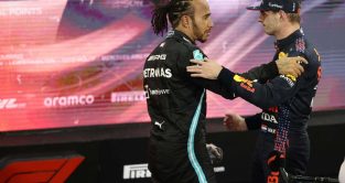 Mercedes and Red Bull drivers Lewis Hamilton and Max Verstappen shake hands. Abu Dhabi December 2021.