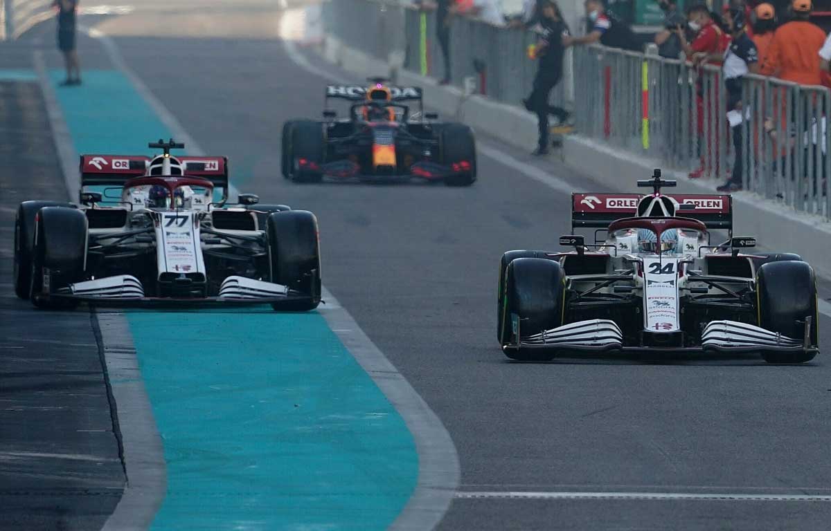 Guanyu Zhou and Valtteri Bottas leave the pits. Abu Dhabi December 2021.