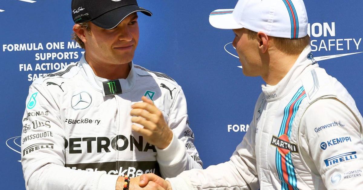Nico Rosberg and Valtteri Bottas shake hands. Germany, July 2014.