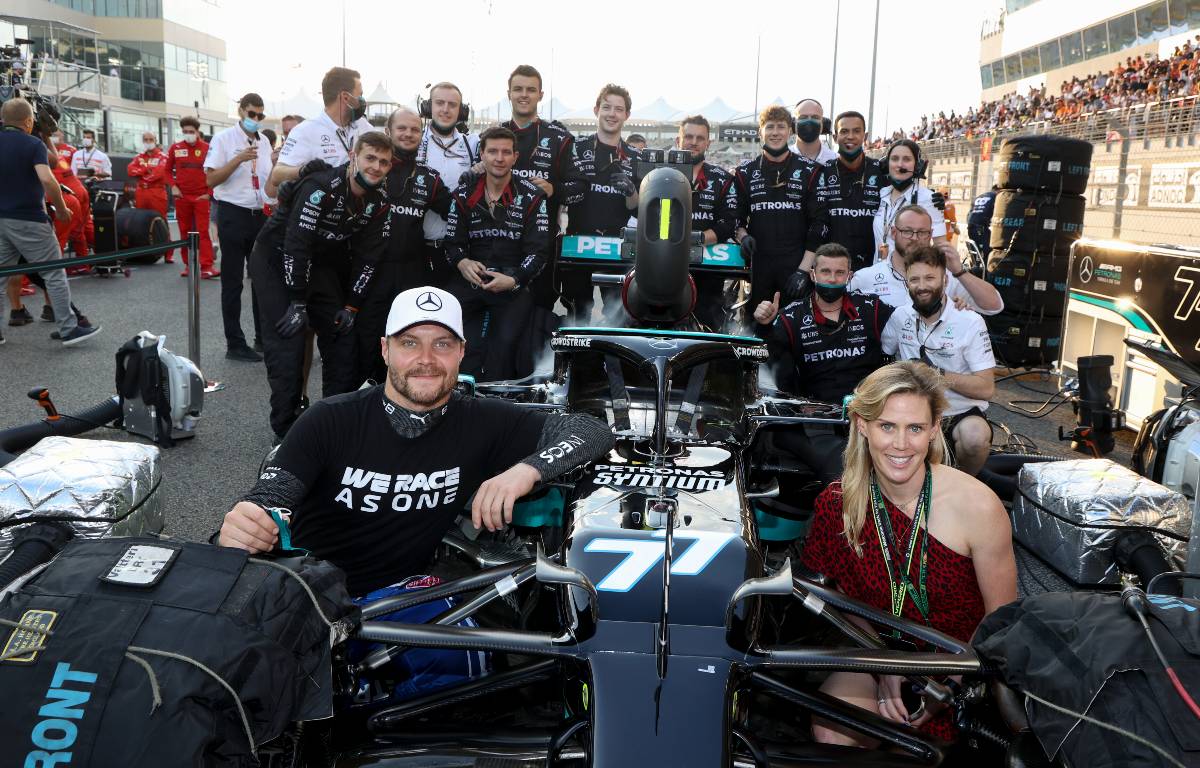 Valtteri Bottas and Tiffany Cromwell pose beside his Mercedes car before the Abu Dhabi GP. Yas Marina December 2021.