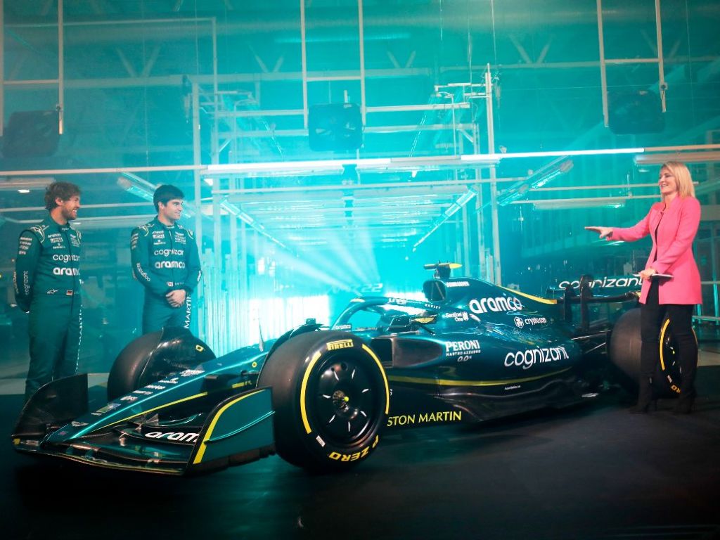Sebastian Vettel and Lance Stroll stand with the AMR22. February 2022.