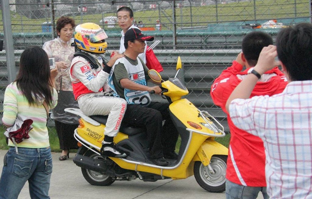 Lewis Hamilton on the back of a scooter after the Chinese GP. Shanghai October 2007.