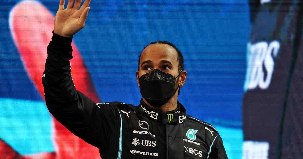 Lewis Hamilton waves on the podium. Abu Dhabi December 2021.