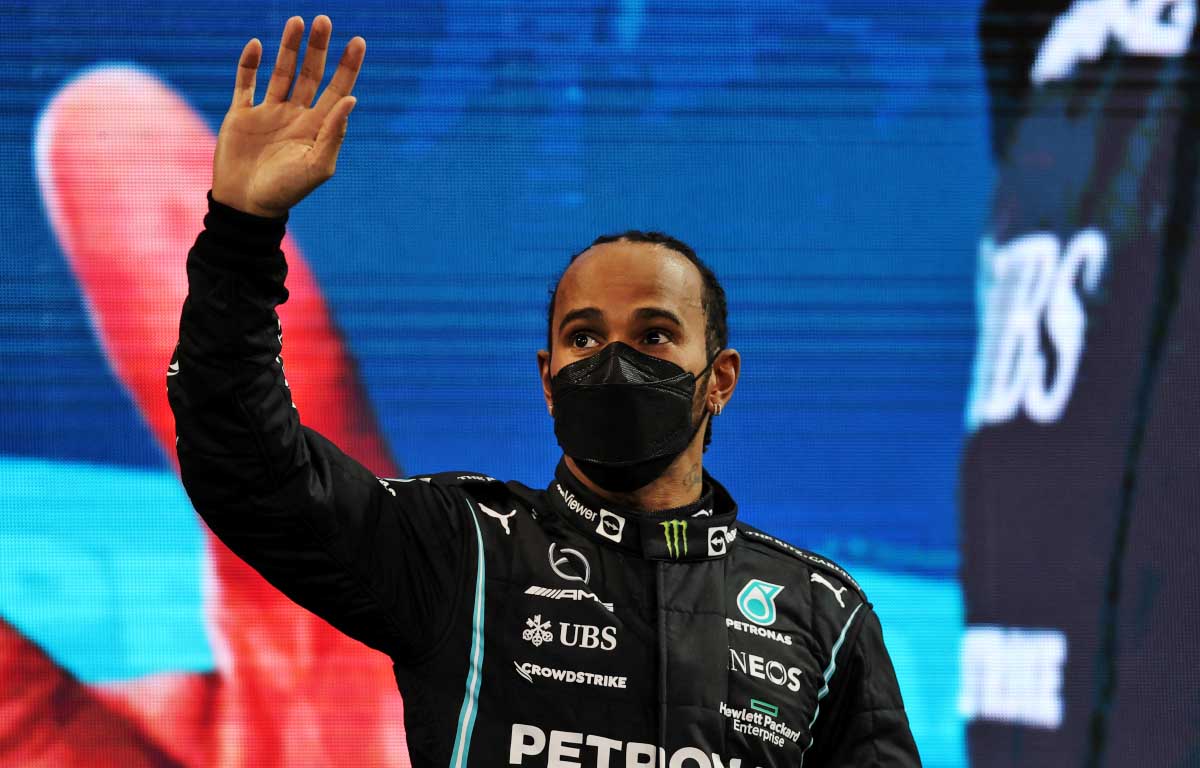 Lewis Hamilton waves on the podium. Abu Dhabi December 2021.
