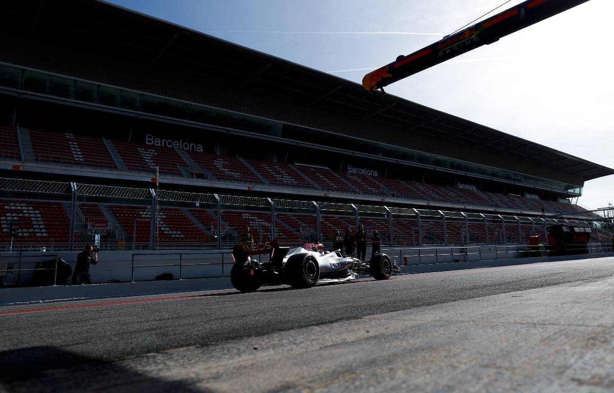 Lewis Hamilton passes an empty stand. Spain, February 2022.