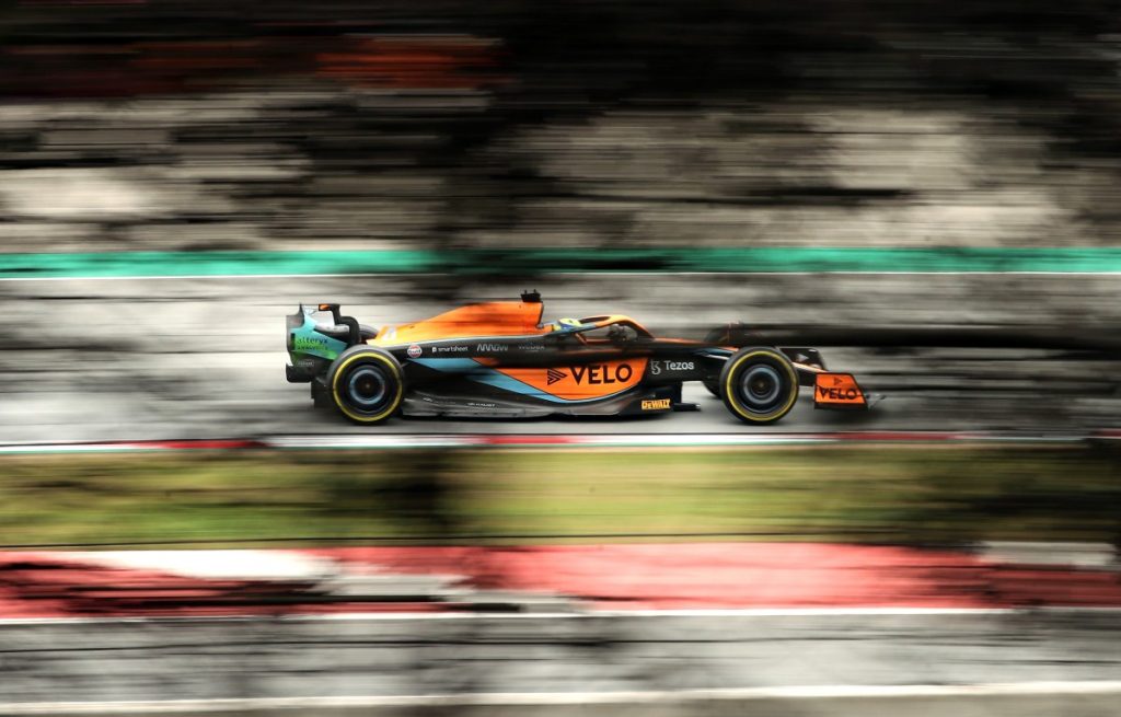 Lando Norris seen through the trees. Spain, February 2022.