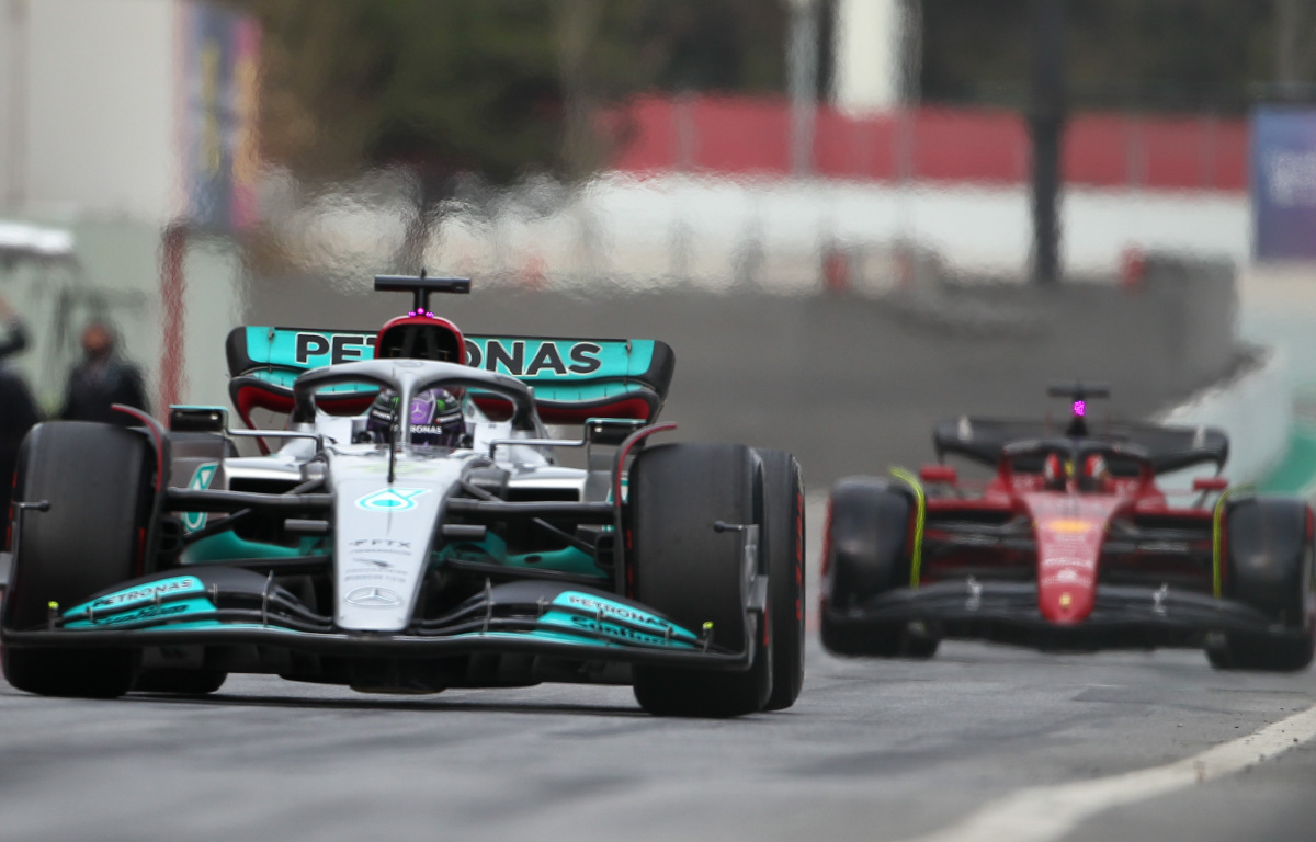 Lewis Hamilton leads Charles Leclerc down the pit lane in testing. Barcelona February 2022
