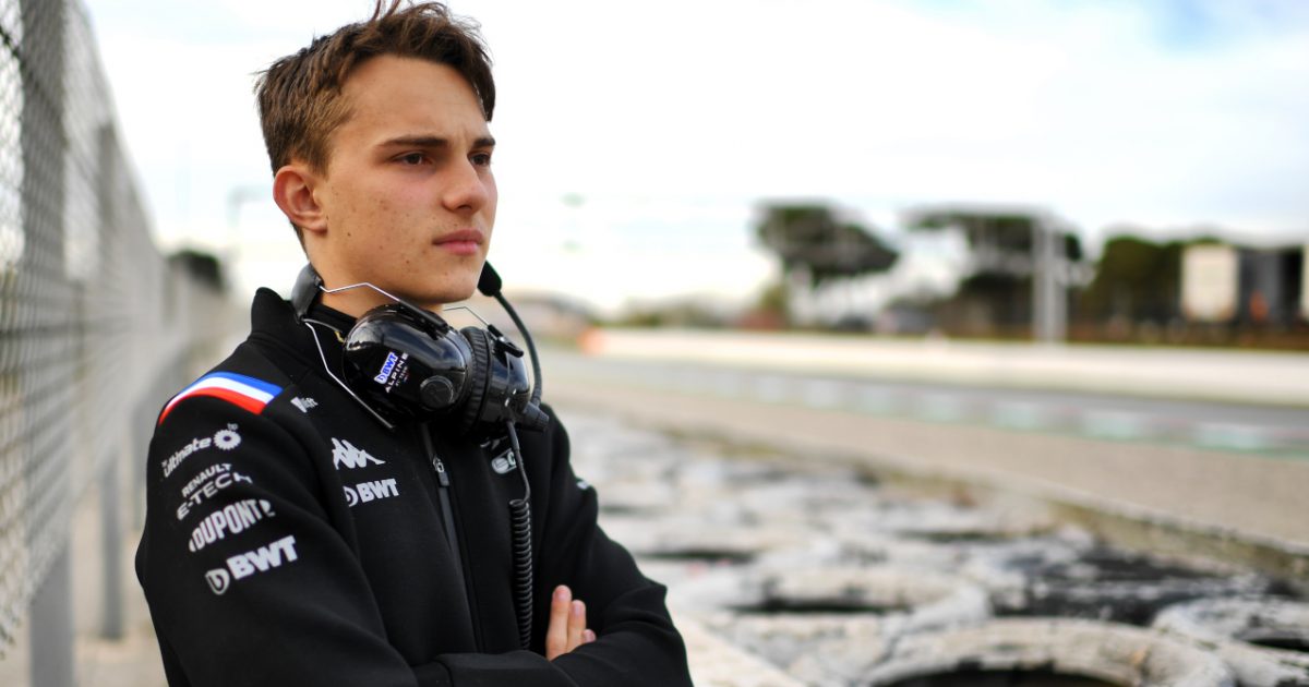 Oscar Piastri arms crossed watching from the sidelines in testing. Barcelona February 2022
