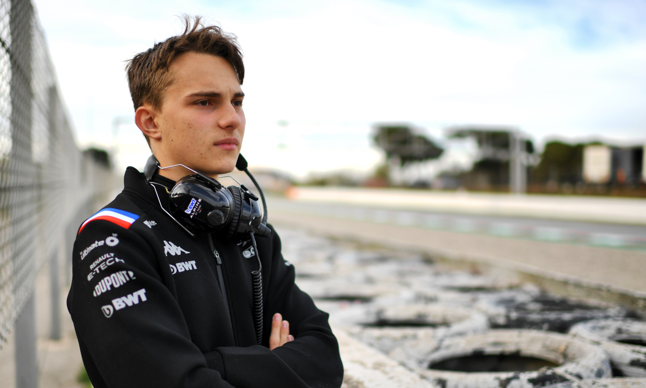 Oscar Piastri arms crossed watching from the sidelines in testing. Barcelona February 2022