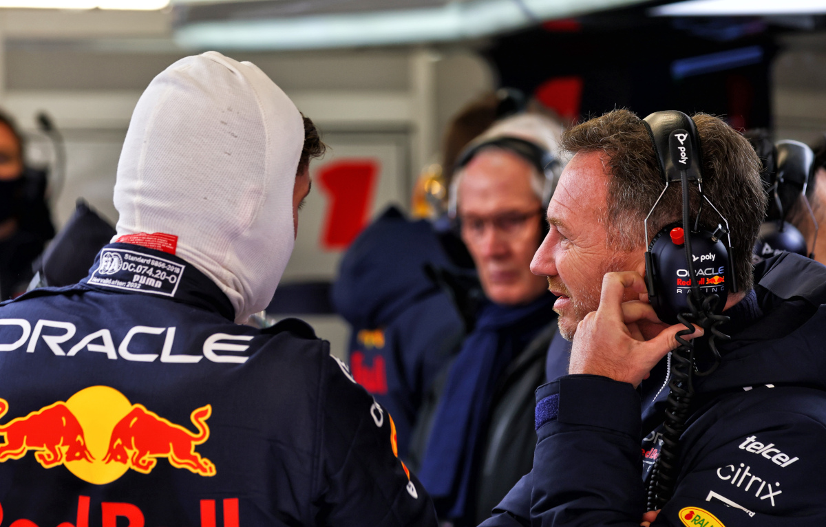 Christian Horner speaking with Max Verstappen, Helmut Marko in the background. Barcelona February 2022